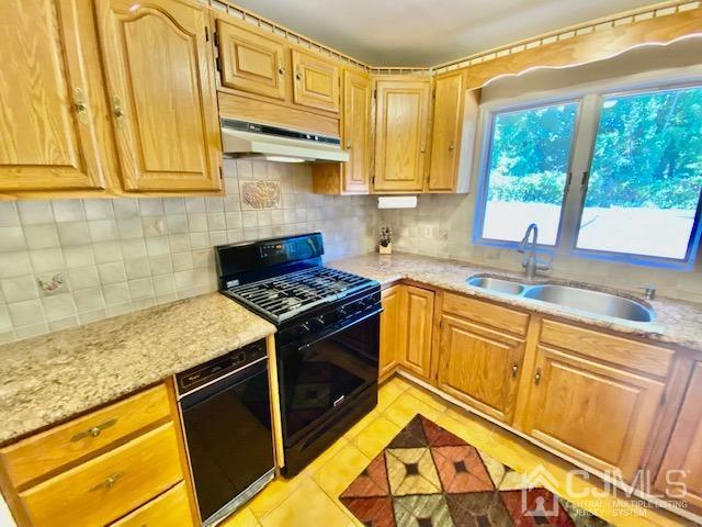 166 Lloyd Road Aberdeen, NJ 07747 - Photo 21 of 56 a kitchen with stainless steel appliances granite countertop a sink stove and cabinets