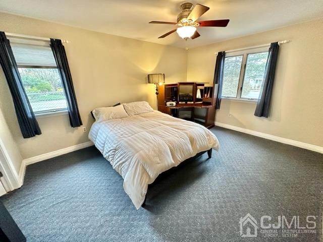 166 Lloyd Road Aberdeen, NJ 07747 - Photo 33 of 56 a bedroom with a large bed a flat tv screen and a dresser