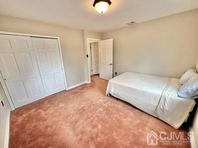 166 Lloyd Road Aberdeen, NJ 07747 - Photo 38 of 56 a spacious bedroom with a bed and with the bathroom