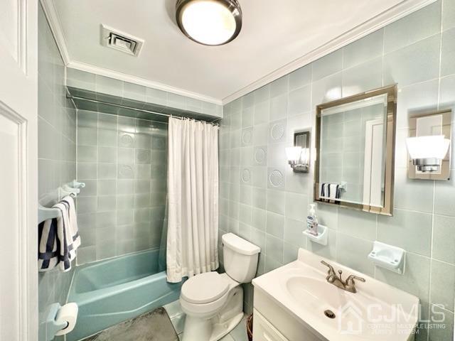 166 Lloyd Road Aberdeen, NJ 07747 - Photo 39 of 56 a bathroom with a sink a toilet and shower