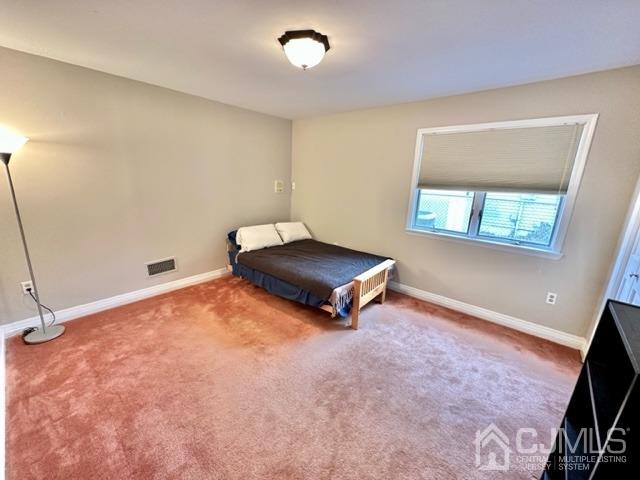 166 Lloyd Road Aberdeen, NJ 07747 - Photo 40 of 56 a bedroom with a bed and a window