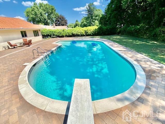 166 Lloyd Road Aberdeen, NJ 07747 - Photo 4 of 56 a view of a swimming pool with a yard