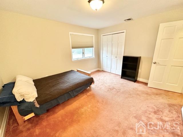 166 Lloyd Road Aberdeen, NJ 07747 - Photo 41 of 56 a bedroom with a bed and a window