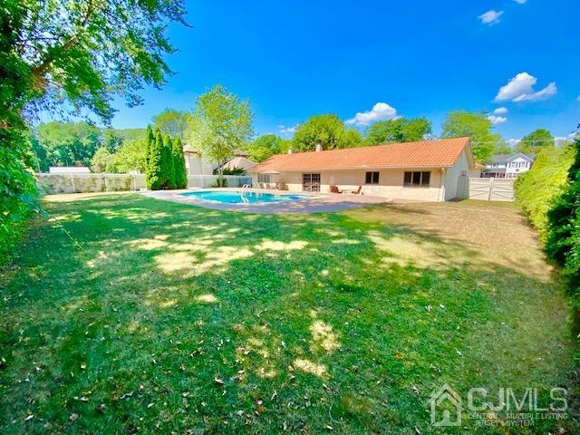 166 Lloyd Road Aberdeen, NJ 07747 - Photo 46 of 56 a backyard of a house with table and chairs plants and large tree