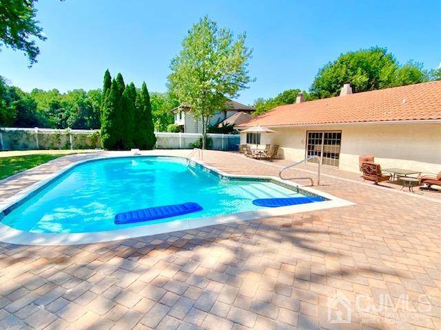 166 Lloyd Road Aberdeen, NJ 07747 - Photo 53 of 56 a view of a house with swimming pool and a yard