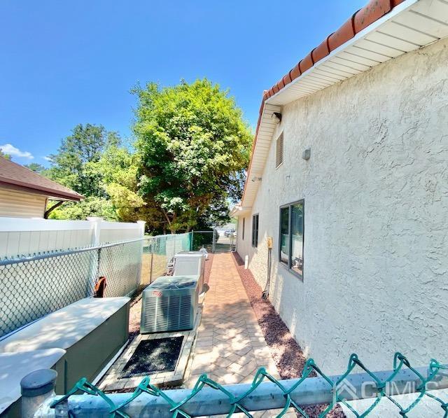 166 Lloyd Road Aberdeen, NJ 07747 - Photo 54 of 56 a view of a patio with table and chairs with wooden floor and fence