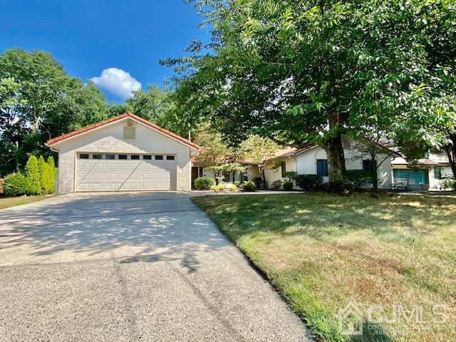 166 Lloyd Road Aberdeen, NJ 07747 - Photo 56 of 56 a front view of a house with a yard and garage