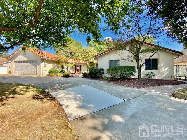 166 Lloyd Road Aberdeen, NJ 07747 - Photo 6 of 56 a front view of a house with a yard and garage