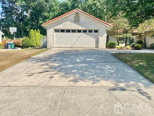166 Lloyd Road Aberdeen, NJ 07747 - Photo 7 of 56 a front view of a house with a yard and garage