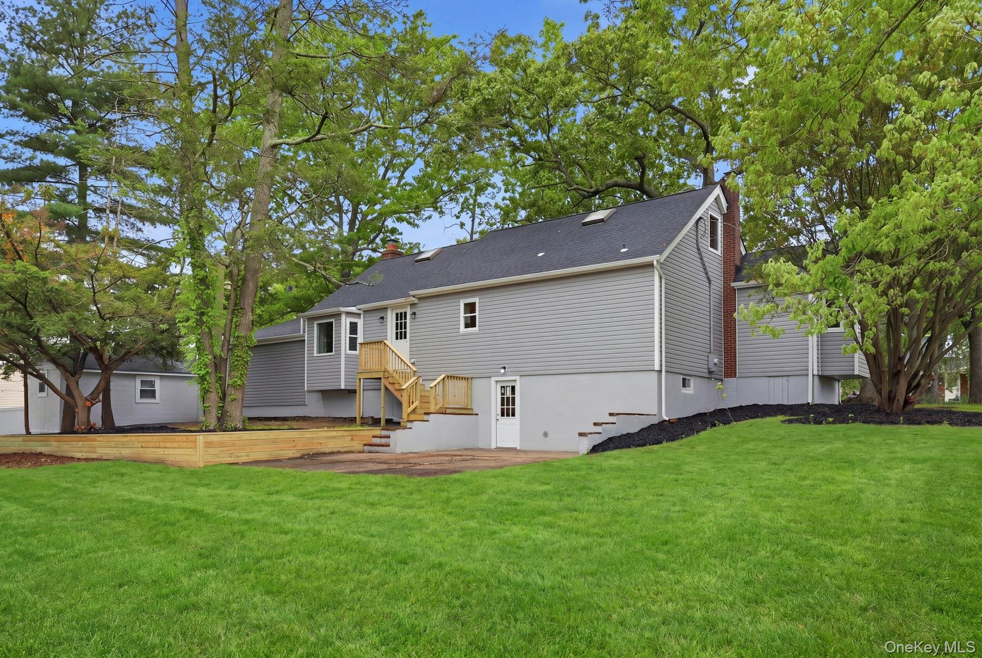 101 Rustic Road Centereach, NY 11720 - Photo 5 of 42 a front view of house with yard and trees