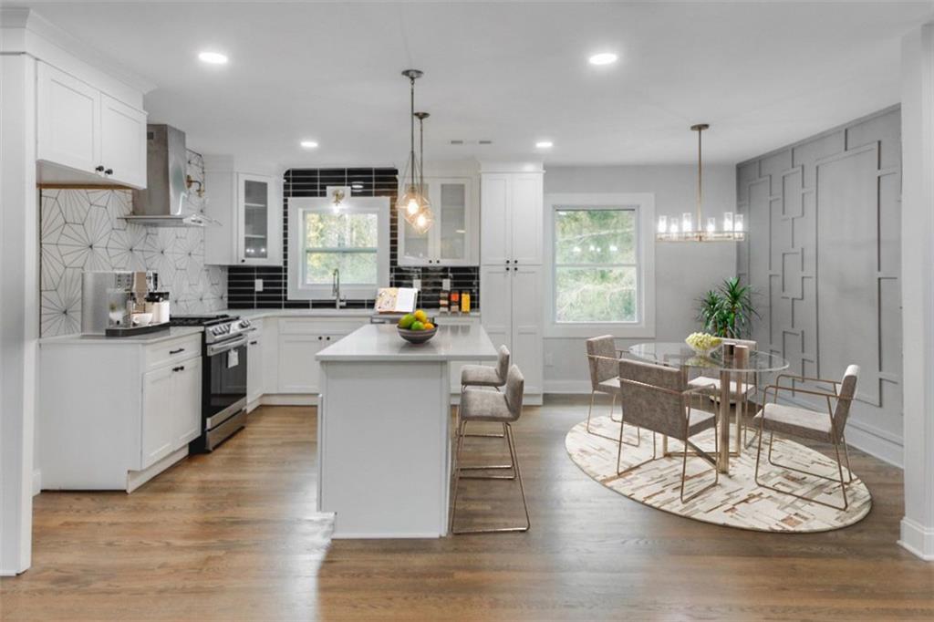 2254 Tilson Circle Decatur, GA 30032 - Photo 1 of 1 a kitchen with a table chairs stove and white cabinets