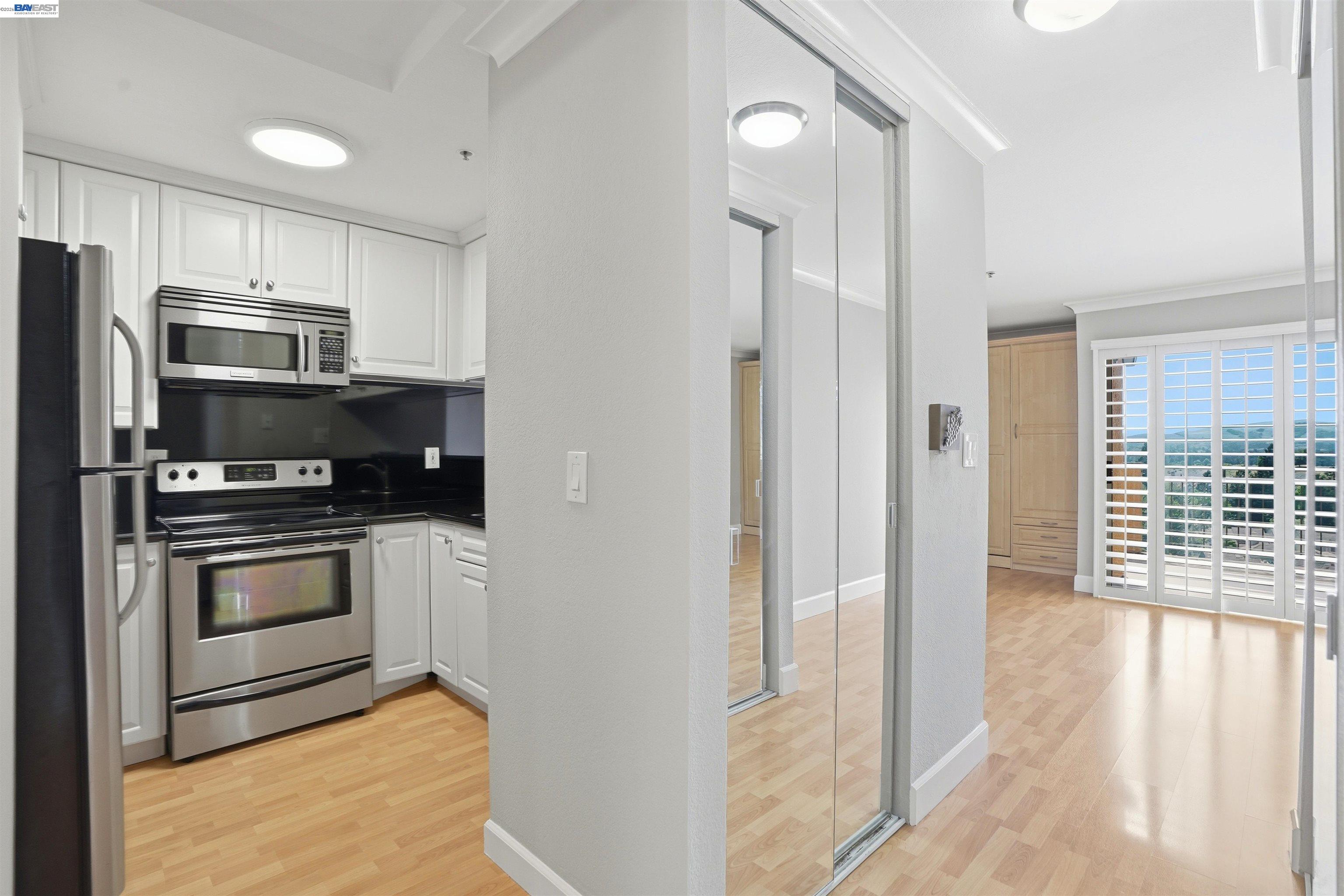 735 Watson Canyon Court, Unit 218 San Ramon, CA 94582 - Photo 2 of 18 a kitchen with stainless steel appliances a refrigerator stove and microwave