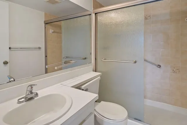 a bathroom with a sink toilet and shower