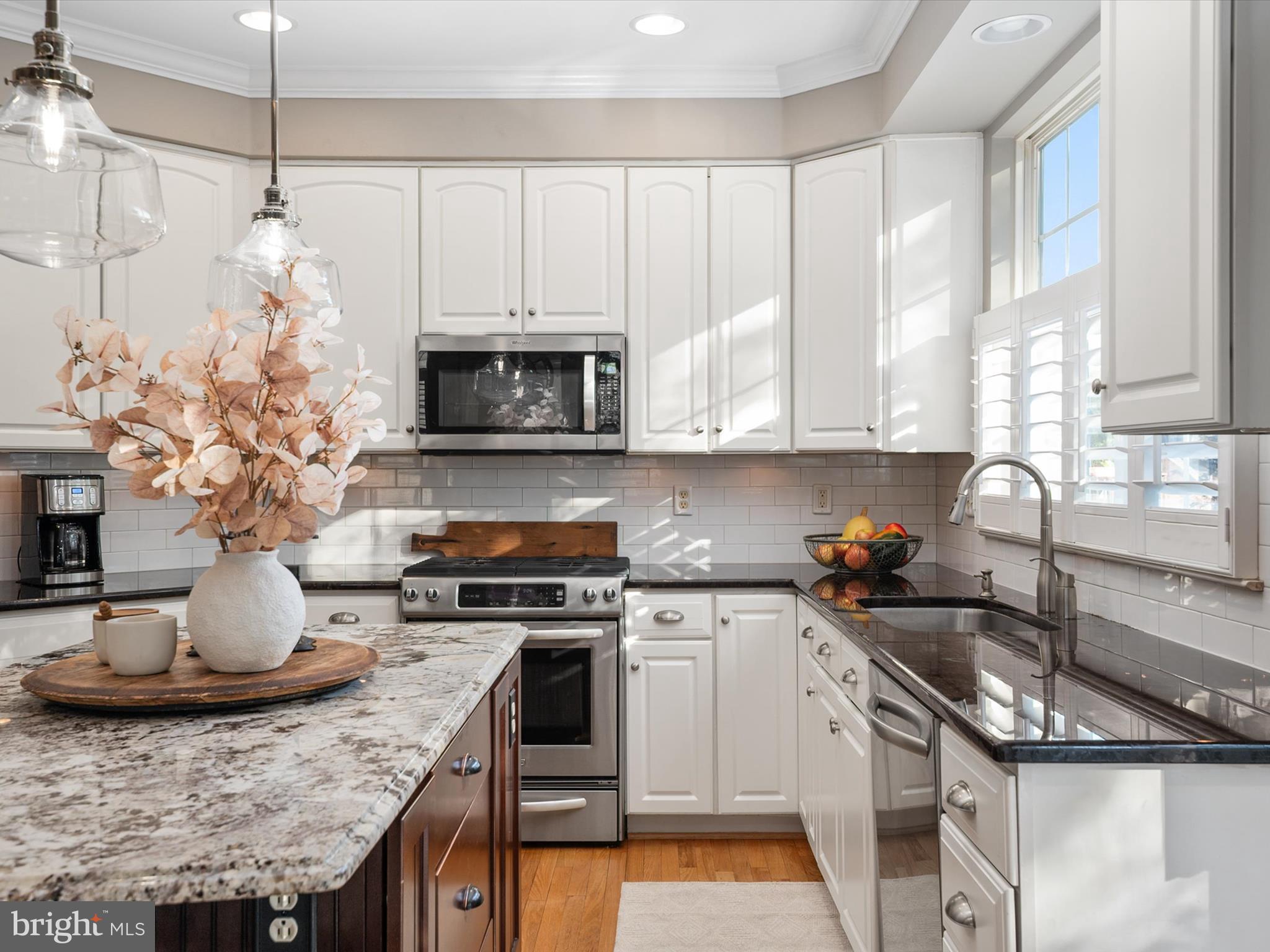 6209 Gatepost Way Elkridge, MD 21075 - Photo 22 of 74 a kitchen with stainless steel appliances granite countertop a sink a stove and a microwave