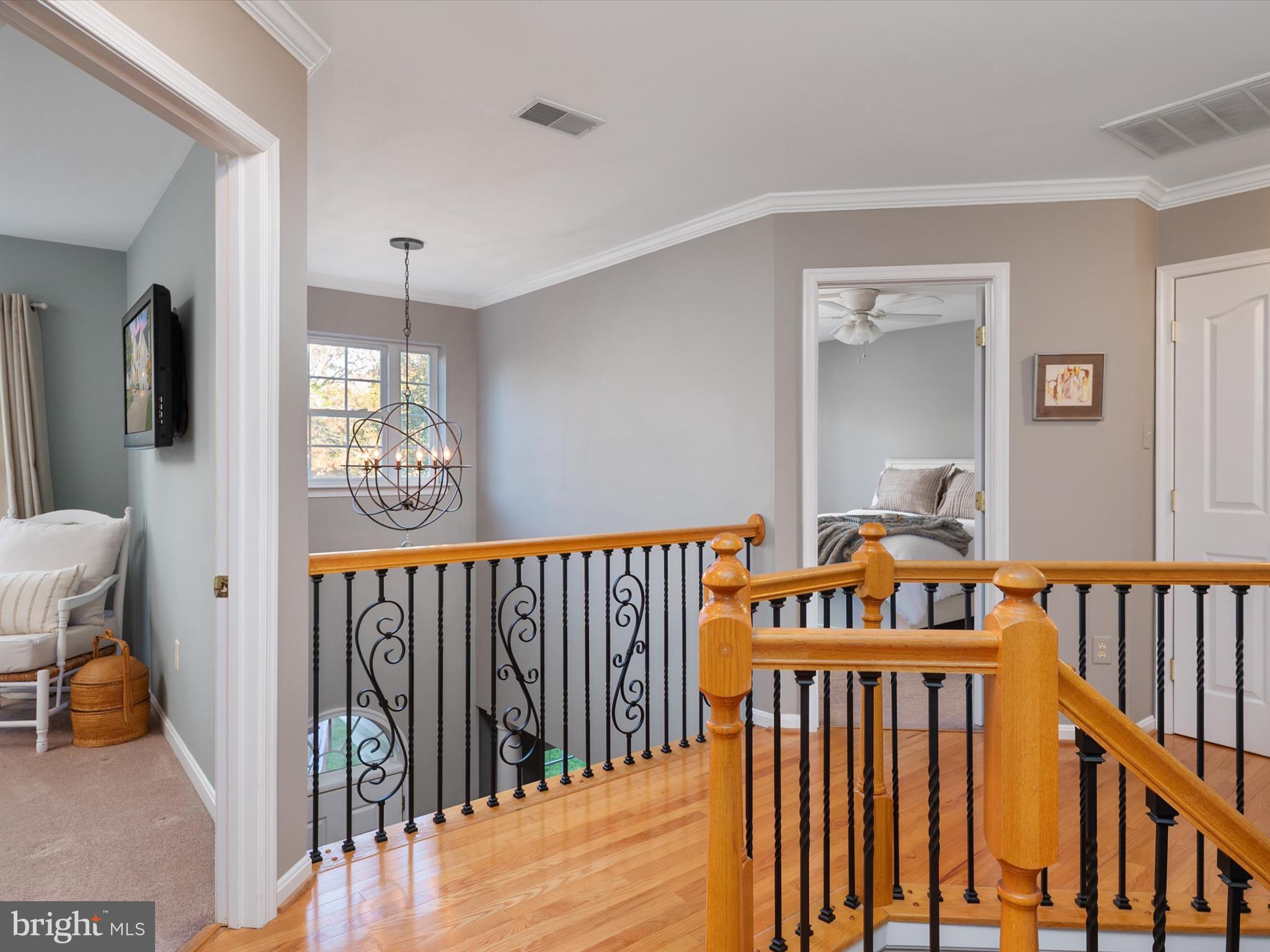 6209 Gatepost Way Elkridge, MD 21075 - Photo 29 of 74 a view of hallway with wooden floor and stairs