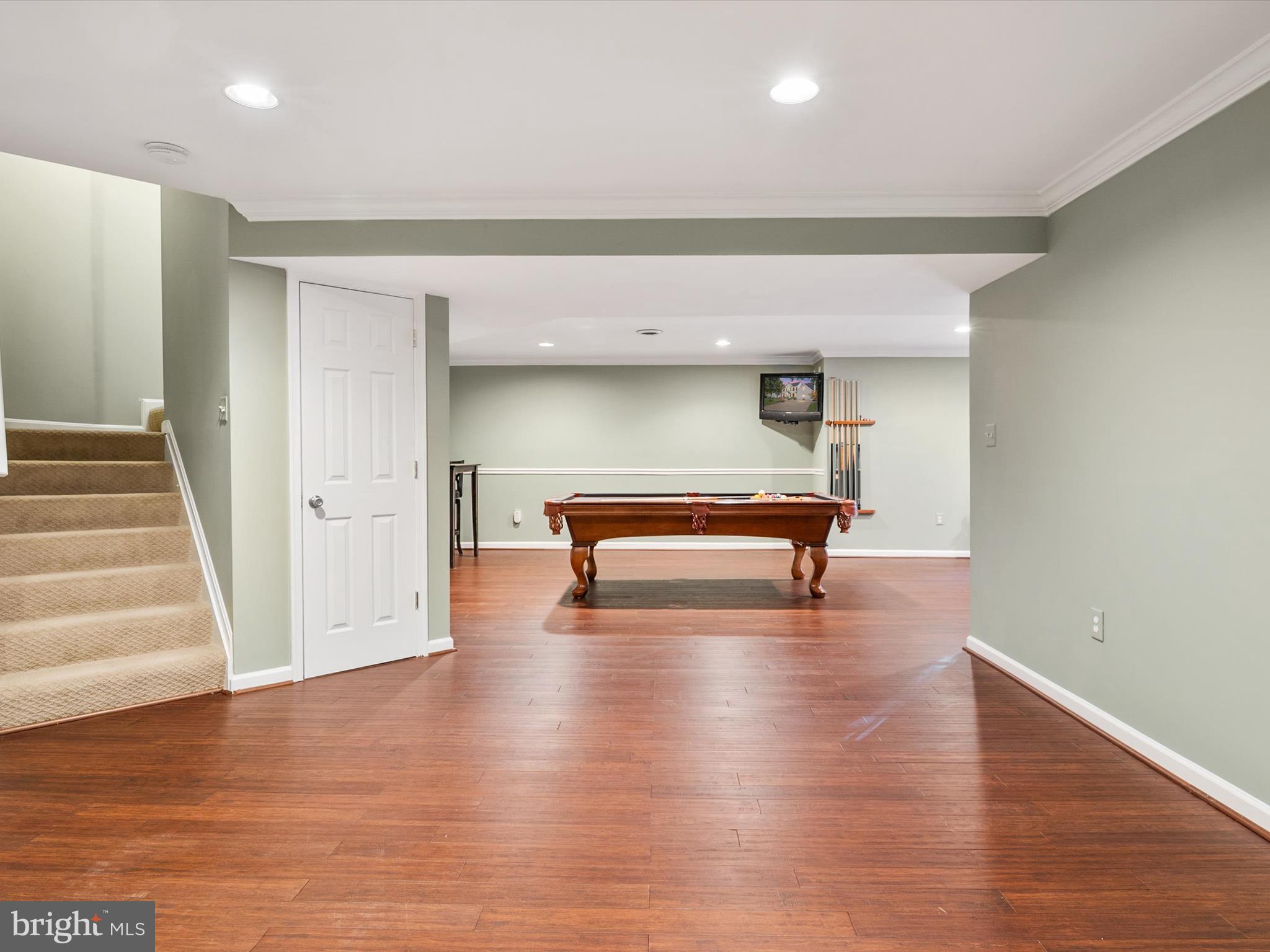 6209 Gatepost Way Elkridge, MD 21075 - Photo 44 of 74 a view of a room with wooden floor and staircase