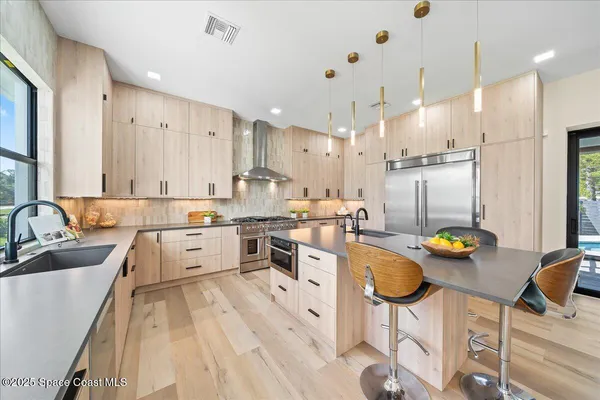 a large white kitchen with lots of counter space and furniture