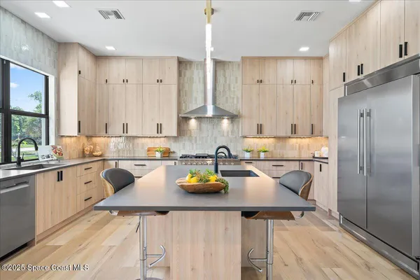 a kitchen with a sink appliances and cabinets