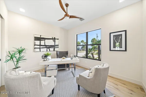 a living room with furniture and a potted plant