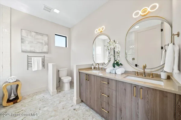 a bathroom with a double vanity sink and a mirror
