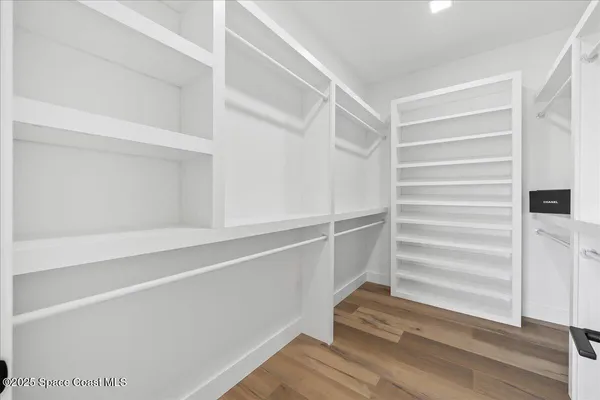 a view of walk in closet with empty racks