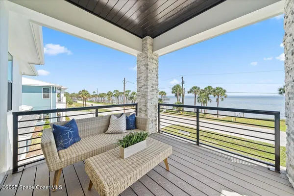 a view of a balcony with furniture