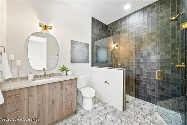 a bathroom with a double vanity sink toilet and shower