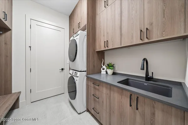 a kitchen with stainless steel appliances granite countertop a sink a refrigerator and cabinets