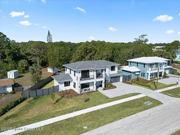 an aerial view of a house with a big yard