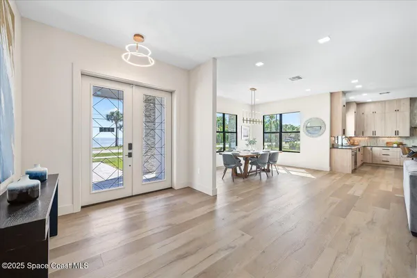 a living room with furniture and a table with wooden floor