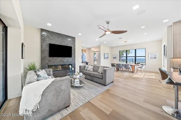 a living room with furniture a fireplace and a flat screen tv