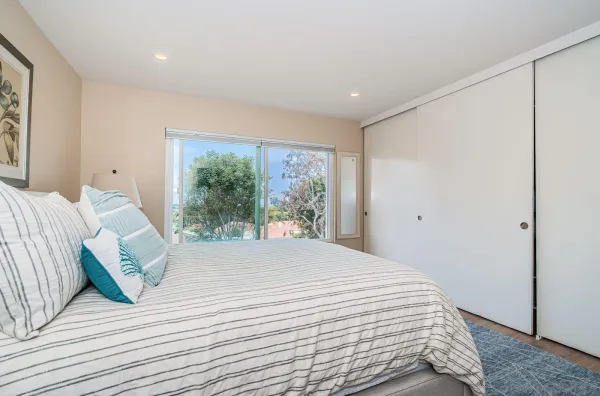 a large white bed in a white room