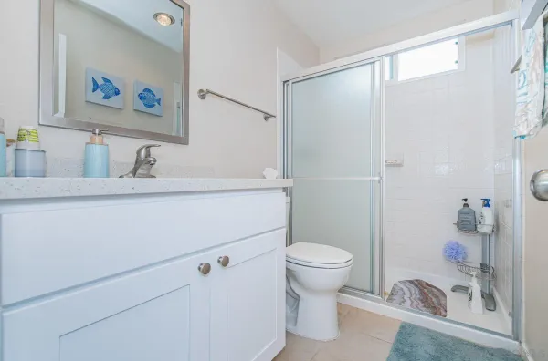 a bathroom with a sink a toilet and a shower