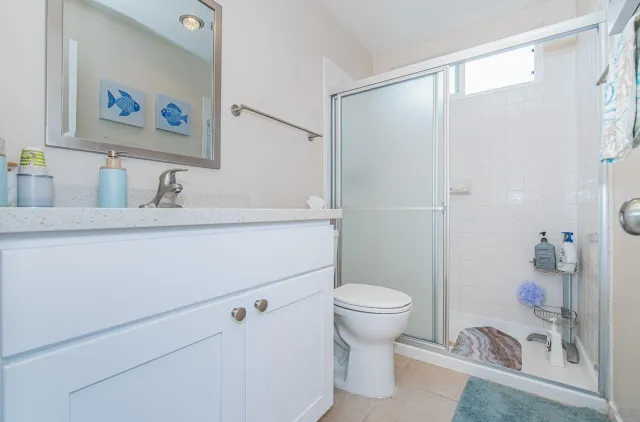 a bathroom with a sink a toilet and a shower