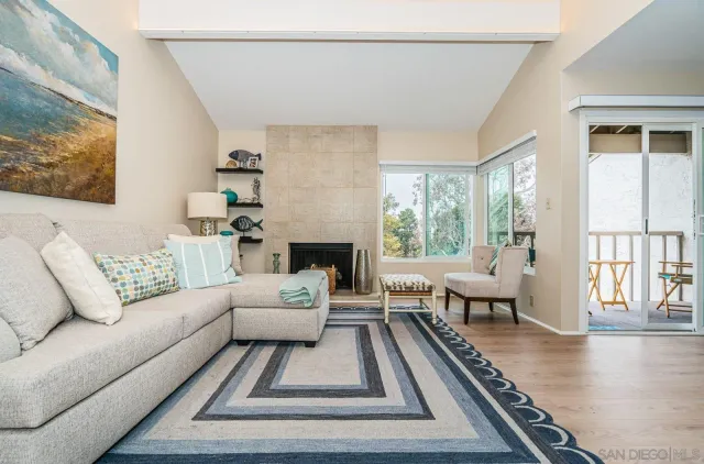 a living room with furniture and a table with wooden floor
