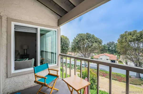 a view of a two chairs in the balcony