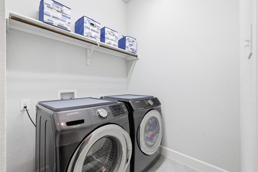 1701 Shetland Road Aubrey, TX 76227 - Photo 11 of 31 a utility room with dryer and washer