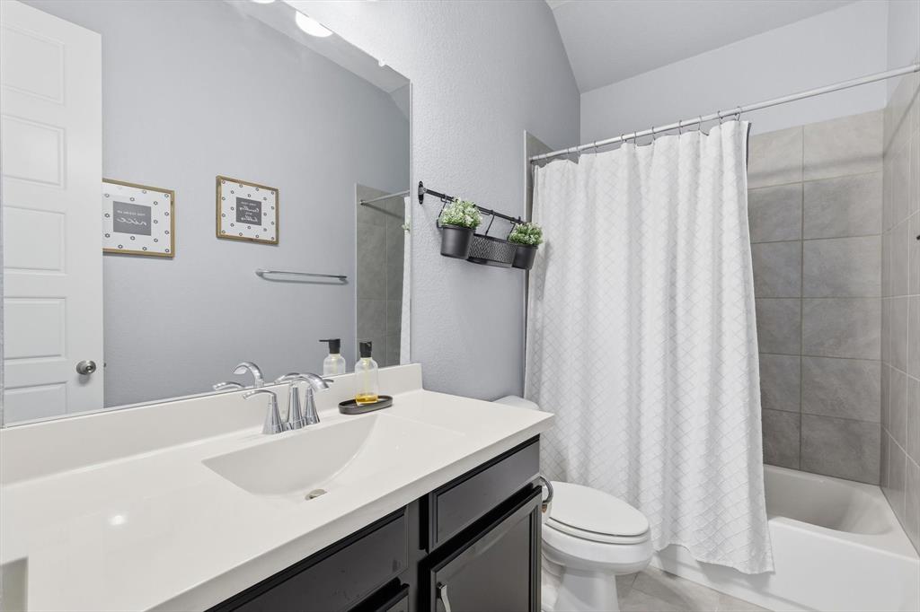 1701 Shetland Road Aubrey, TX 76227 - Photo 17 of 31 a bathroom with a sink toilet and shower