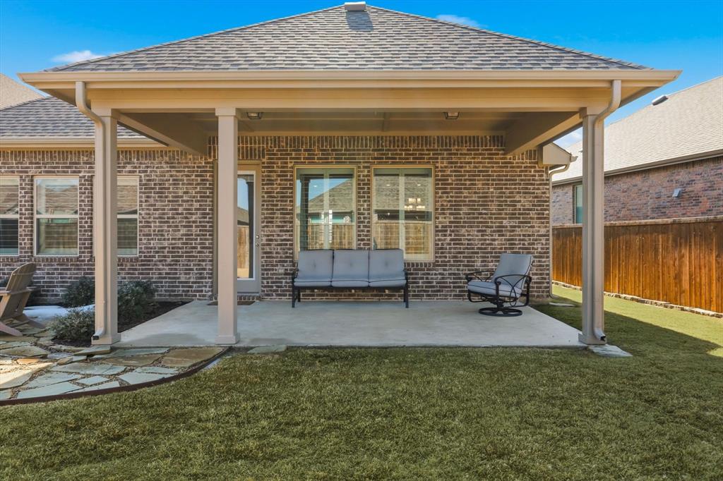 1701 Shetland Road Aubrey, TX 76227 - Photo 19 of 31 a view of a porch with a table and chairs