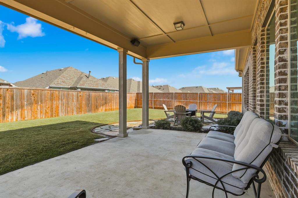 1701 Shetland Road Aubrey, TX 76227 - Photo 3 of 31 a view of a patio with a table chairs and a backyard