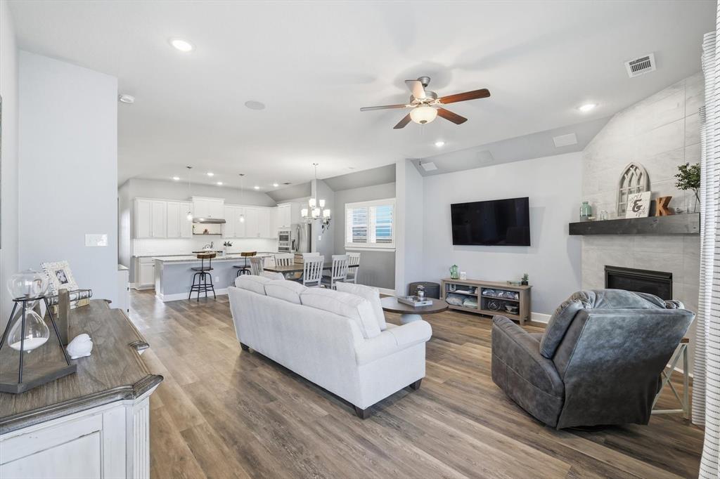 1701 Shetland Road Aubrey, TX 76227 - Photo 8 of 31 a living room with fireplace furniture and a flat screen tv