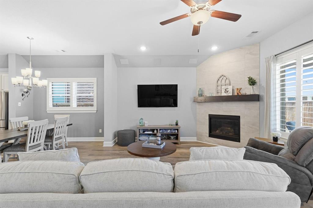1701 Shetland Road Aubrey, TX 76227 - Photo 9 of 31 a living room with furniture fireplace and a flat screen tv