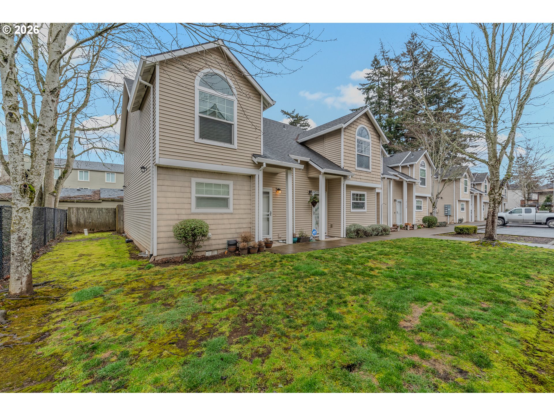 19159 Southeast Yamhill Street, Unit 15 Portland, OR 97233 - Photo 1 of 23 a front view of a house with a yard