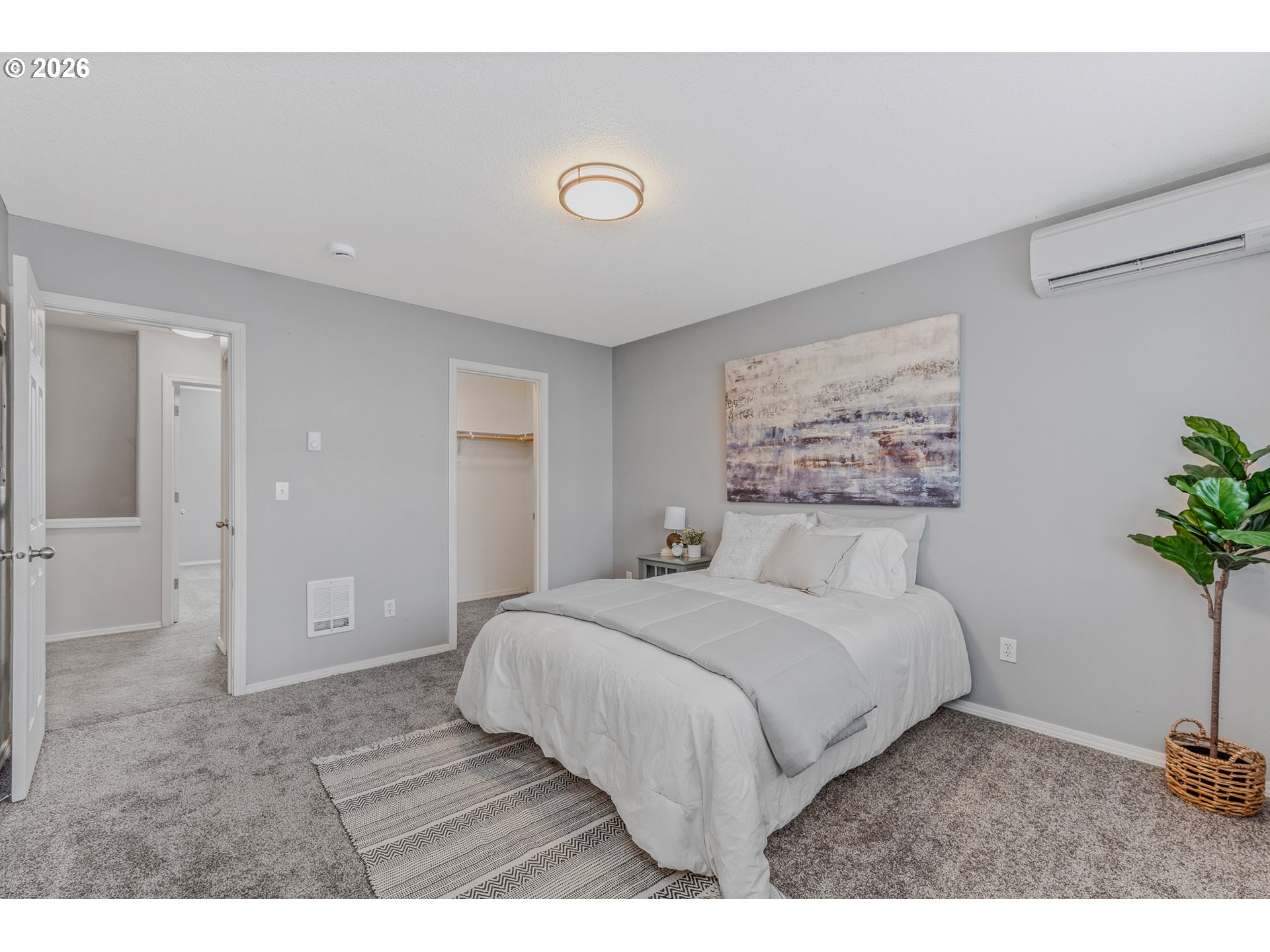 19159 Southeast Yamhill Street, Unit 15 Portland, OR 97233 - Photo 13 of 23 a bedroom with a large bed and a potted plant