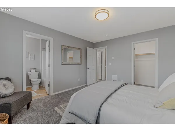 a bedroom with a bed and a couch