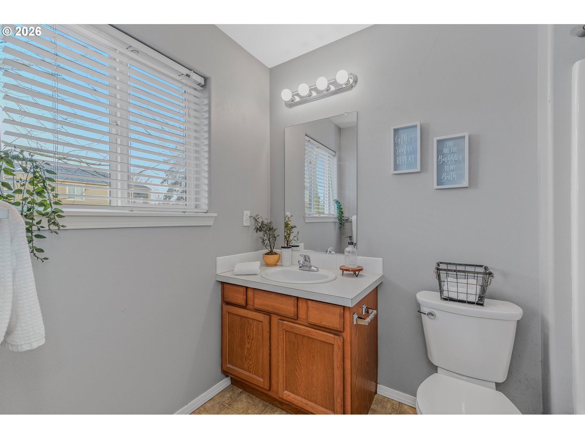19159 Southeast Yamhill Street, Unit 15 Portland, OR 97233 - Photo 15 of 23 a bathroom with a toilet sink and mirror