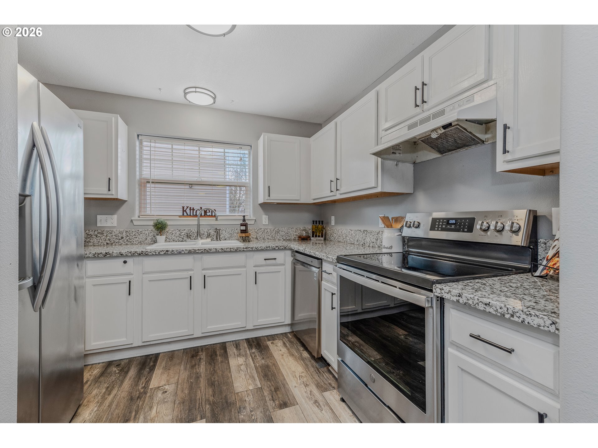 19159 Southeast Yamhill Street, Unit 15 Portland, OR 97233 - Photo 2 of 23 a kitchen with granite countertop a stove sink and refrigerator