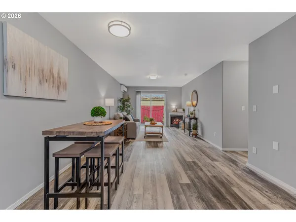 a dining room with furniture and wooden floor