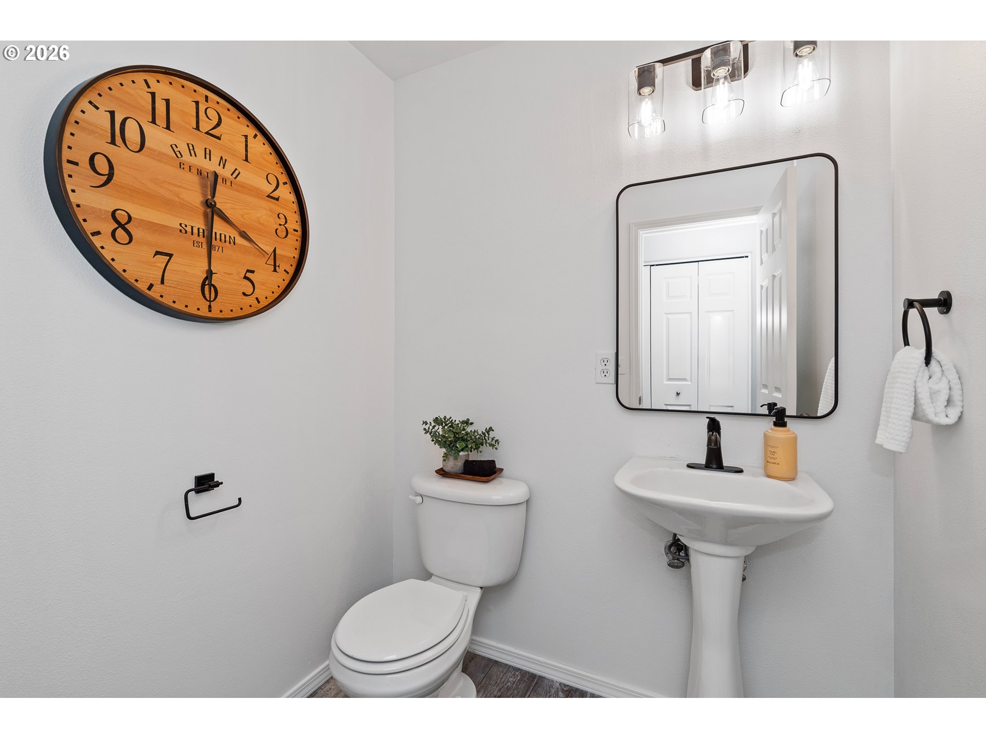 19159 Southeast Yamhill Street, Unit 15 Portland, OR 97233 - Photo 10 of 23 a bathroom with a toilet a sink and a mirror
