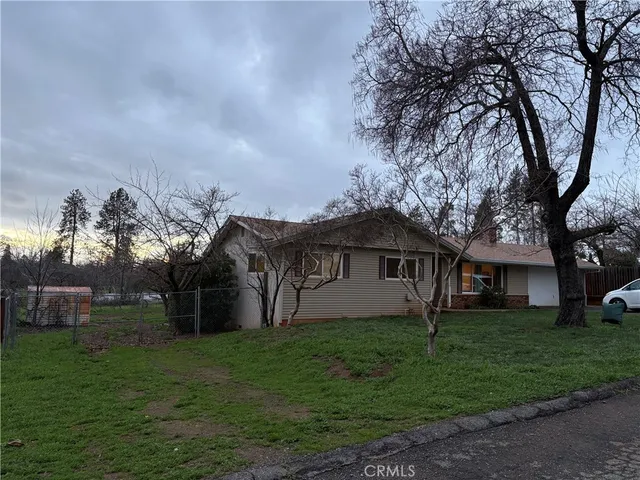 a view of house with a yard